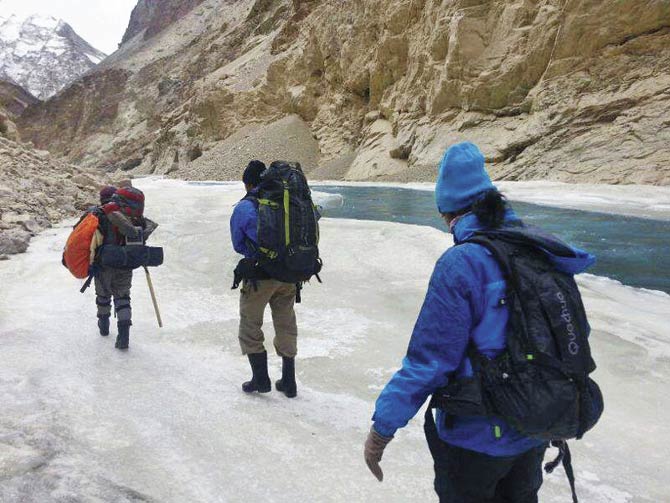 The porters carrying trekker’s bags in the Himalayas