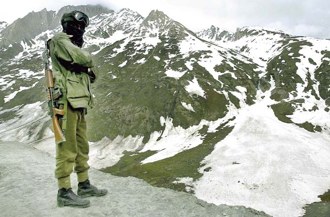 An Indian soldier guards the highway leading to Kashmir’s Kargil area in 2001. Former Intelligence chief AS Dulat knows a lot about how India handled the Kashmir issue in those crucial years when we fought the Kargil war. Pic/AFP