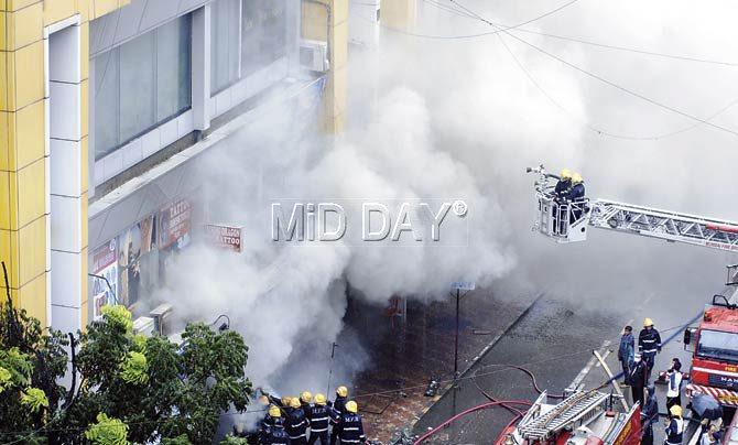 Firemen attempt to douse the fire at Kenilworth Mall on Linking Road on Tuesday morning. Pic/Rane Ashish
