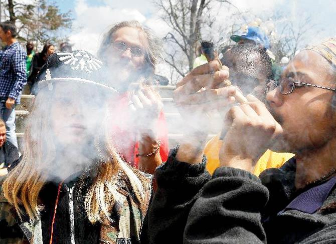 Partygoers listen to music and smoke marijuana during the annual 4/20 marijuana festival in Denver’s downtown Civic Centre Park in April this year. Pic/AP