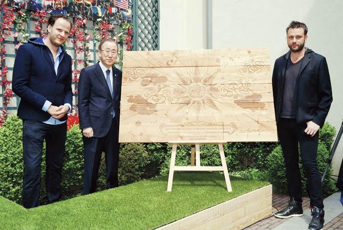 Manu (left) and Michiel Beers, (right) co-founders of Tomorrowland, pose with UN Secretary-General Ban Ki-Moon, whose message was engraved for posterity on a piece of wood and will be added to the permanent bridge at the recreational domain De Schorre in Boom. Pic/AFP