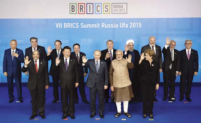 IMF has predicted that the Indian economy will be the fastest growing one in the coming year. PM Narendra Modi poses for a family photo during the 7th BRICS summit in Ufa, Russia with his political counterparts