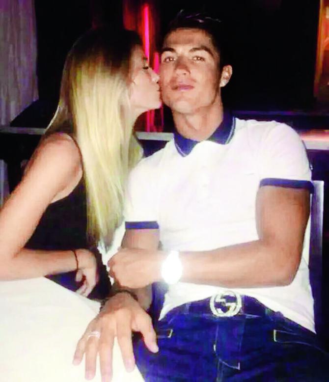 Ronaldo is kissed by one of Woolstenhulme’s friends during their night out in Las Vegas recently 