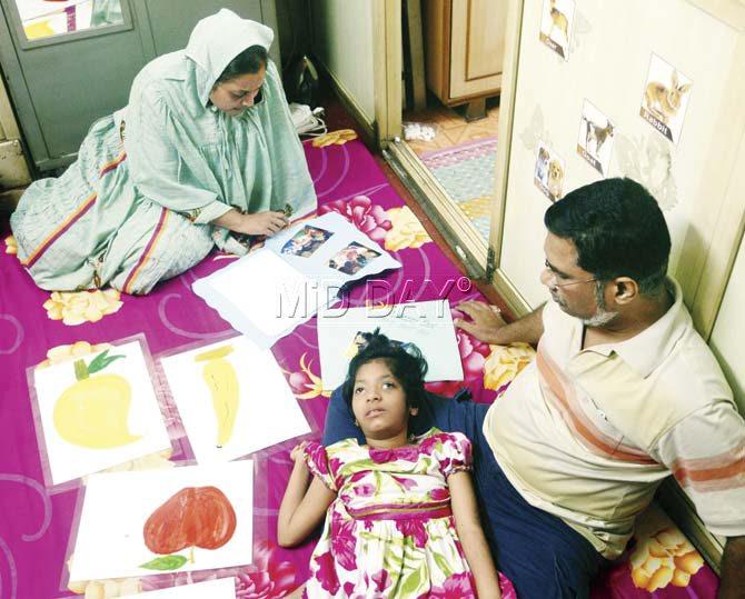 Ruqayyah with her parents at their house