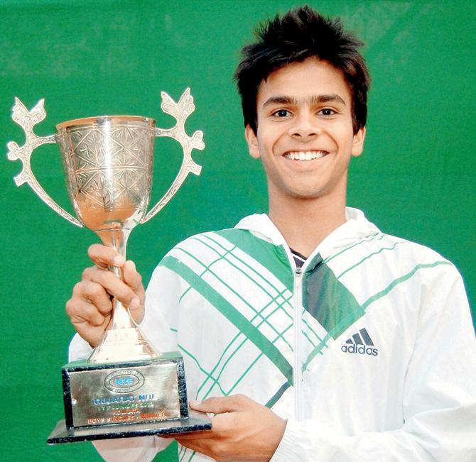Indian teenager Sumit Nagal with the Wimbledon boys doubles winners’ trophy yesterday. Pic/PTI 