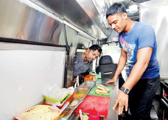 It cost Sagar Waghule (left), Suraj Kurkute (right) and Sudhir Kanse, who run Mumbai Rolling Kitchen outside corporate center Mindspace in Airoli, R12 lakh to convert a Tata Winger into a fully equipped, fire proof food truck.  Pics/Sameer Markande