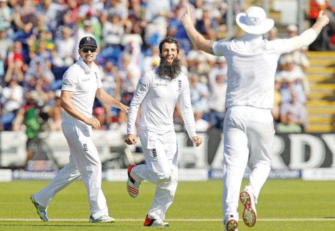 England’s Moeen Ali celebrates the wicket of Australia captain Michael Clarke