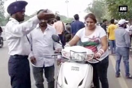 Traffic police let riders buy helmets to avoid fines