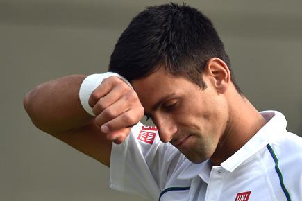 Wimbledon: Novak Djokovic fightback halted by bad light