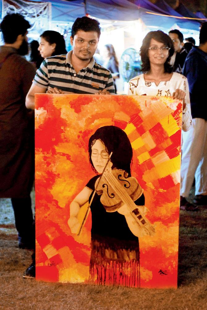 Abhishek Panchal and Raisa D’Souza with the charcoal-acrylic fusion painting at this year’s Bandra festival 