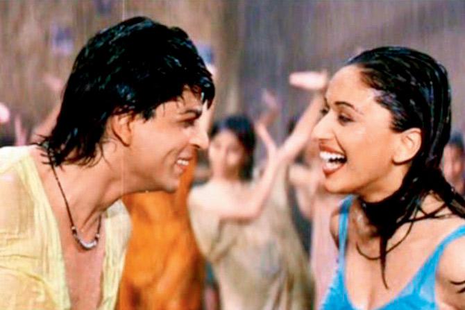 Shah Rukh Khan (left) and Madhuri Dixit in the Koi Ladki Hai track in Dil To Pagal Hai (1997) grow closer to each other during the downpour