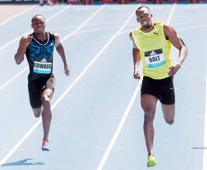 Usain Bolt (right) crosses the finish line ahead of Alonso Edward. Pic:AP/PTI