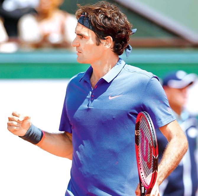 Roger Federer celebrates a point against France