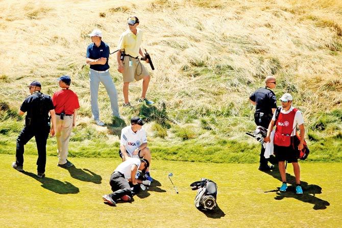 Jason Day is attended to by a doctor during the second round of the US Open on Friday PIC/AFP