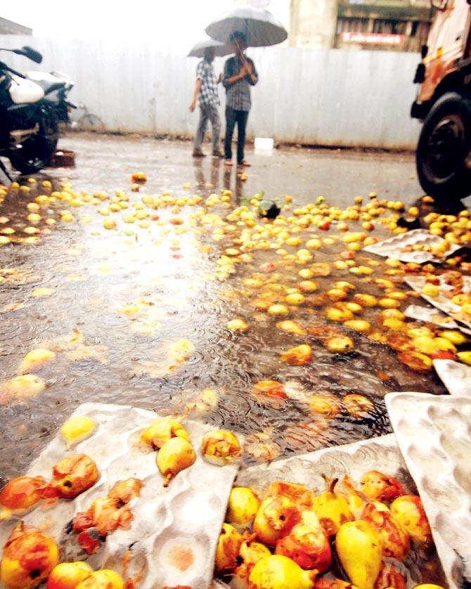 Fruits float in the water inside the market premises. File photo