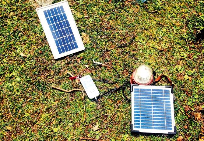 A cellphone has been put on charge on a solar charging device
