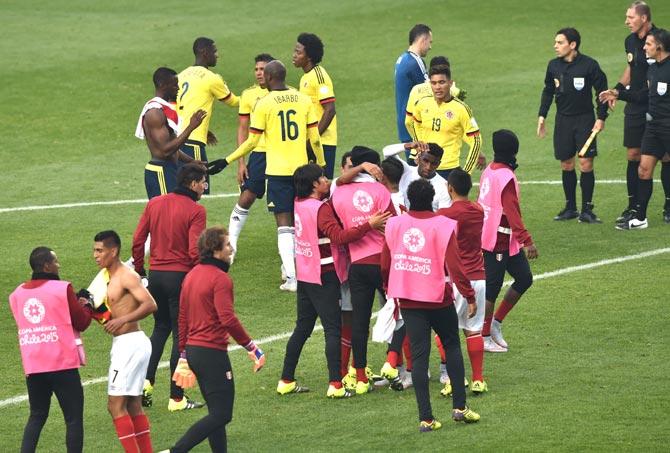 Players of Colombia (yellow) and Peru are seen at the end of their 2015 Copa America football championship match, in Temuco. Pic/AFP
