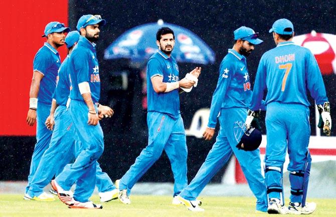 India players walk back to the pavilion during the rain interval against Bangladesh in first ODI at Mirpur on Thursday. Pic:AP/PTI