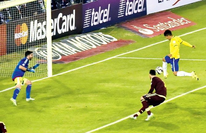 Roberto Firminho (right) shoots to score Brazil