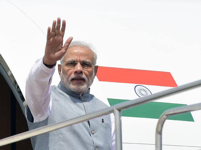 Indian Prime Minister, Narendra Modi waves as he leaves the plane on his arrival at the Hazrat Shahjalal International Airport in Dhaka on June 6, 2015. Pic/PTI