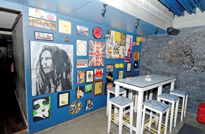 The bar area at Café Lager has a wall with frames of vinyls and artiste pictures such as Bob Marley