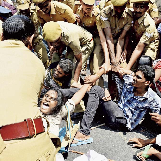 Police detain activists from the Democratic Youth Federation of India (DYFI) during a protest against HRD Minister Smriti Irani and IIT-Madras outside the institute campus in Chennai on Saturday. Pic/PTI