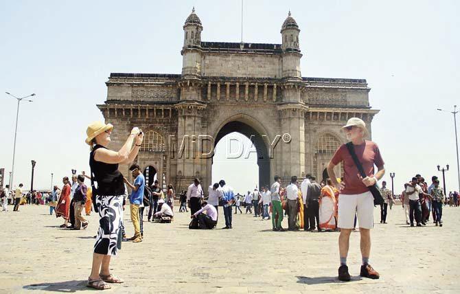 Foreigners look for a photo-op at the Gateway of India. Pic/Sameer Markande