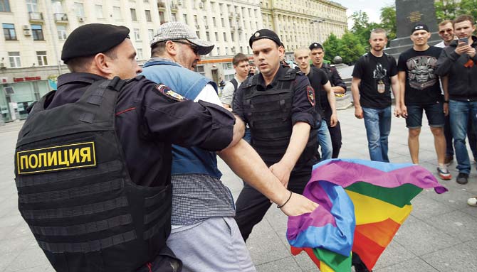 Russian riot policemen detain a LGBT rights activist during an unauthorised gay rights activists rally in central Moscow. Pic/AFP