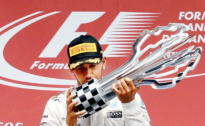 Mercedes’ Lewis Hamilton kisses the trophy on the podium at the Circuit Gilles Villeneuve in Montreal after winning the Canadian GP on Sunday. PIC/AFP