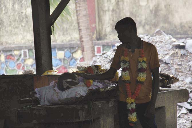 A family member performs the last rites of one of the victims of the Malwani hooch tragedy at a crematorium in Malad. Having claimed 104 lives, this counts as the worst hooch  tragedy in the city