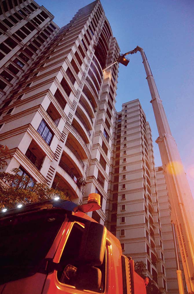Rescue personnel at the scene of the fire that took place on Saturday evening at the Powai building. Pic/AFP