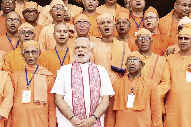 Modi sings hymns with monks at Ramakrishna Mission in Dhaka on Sunday. Pic/PTI
