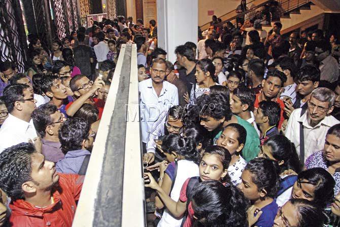 Students and their parents check the first merit list at Ruia College in Matunga to see if they made it. Pic/Suresh KK