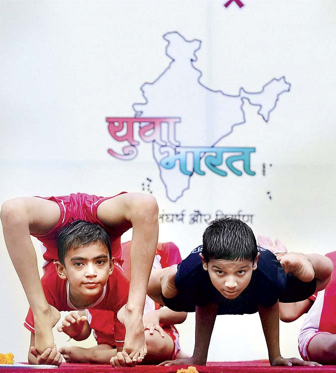 Kids practise for International Yoga Day in Delhi. Pic/PTI