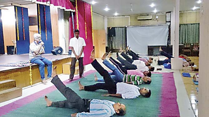 Western Railway employees learn yoga from an instructor, in one of the batches that began on May 25