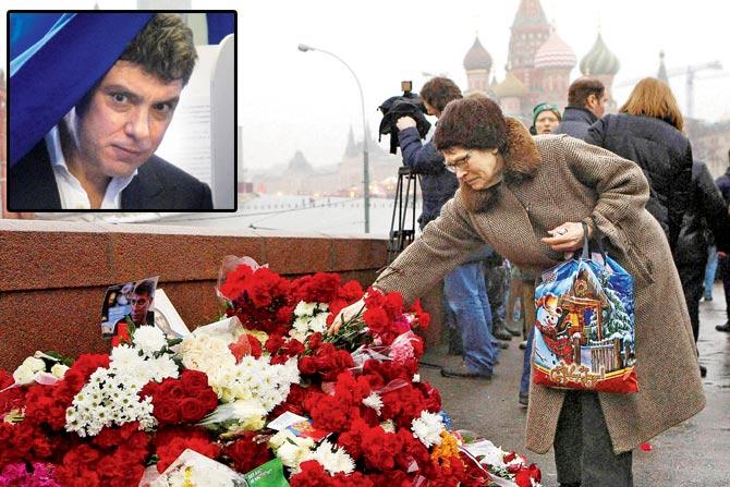 (Above) Four bullets killed opposition leader Boris Nemtsov yesterday. (Right). pic/afp. A woman lays flowers at the place where he was gunned down. Pic/AP 