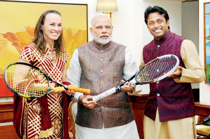 Leander Paes and Martina Hingis present Prime Minister Narendra Modi with the autographed tennis racquets with which they played  the 2015 Australian Open Mixed Doubles final. PIC/PTI