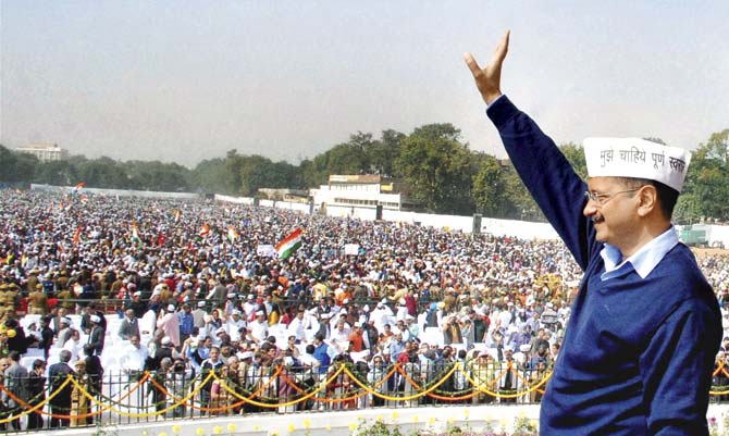 Arvind Kejriwal waves at his supporters during his swearing-in ceremony as Delhi chief minister at Ramlila Maidan in New Delhi on February 14. File pic/PTI