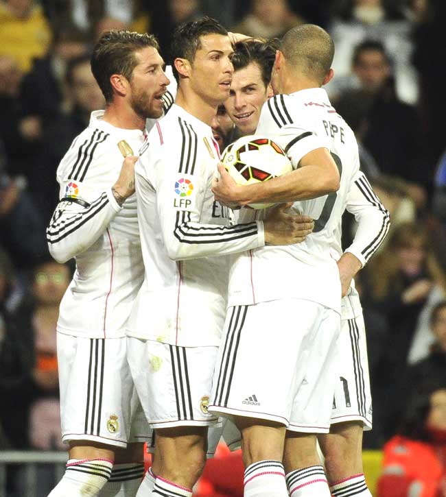 Real Madrid-s Welsh forward Gareth Bale 3rd L celebrates his team-s second goal with teammates Real Madrid-s defender Sergio Ramos L and Real Madrid-s Portuguese forward Cristiano Ronaldo 2nd L during the Spanish league football match Real Madrid CF vs Levante UD at Santiago Bernabeu stadium in Madrid. Pic/AFP