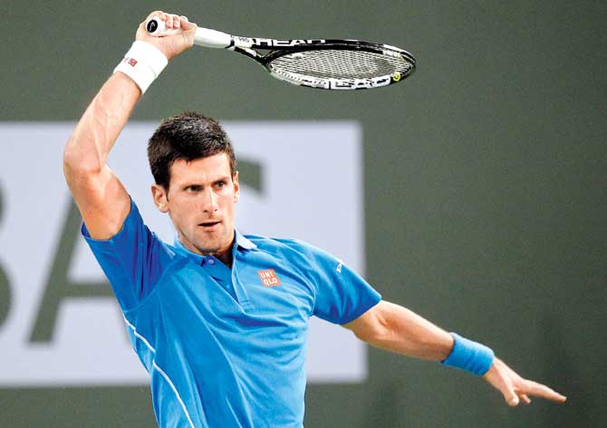 Novak Djokovic hits a forehand against Marcos Baghdatis  in Indian Wells, California. Pic/AFP
