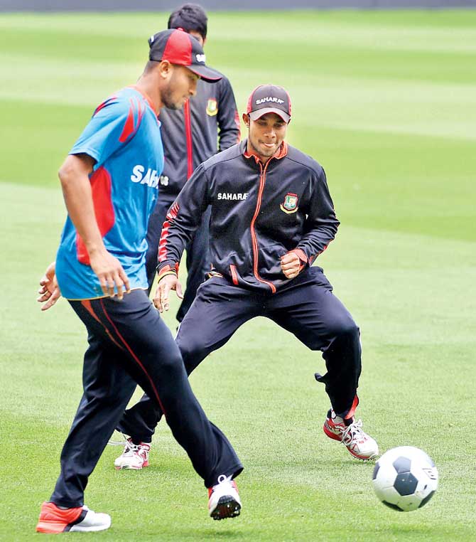 Shakib Al Hasan (left) plays football with teammate Sabbir Rahman during a training session in Melbourne yesterday. Pic/AFP
