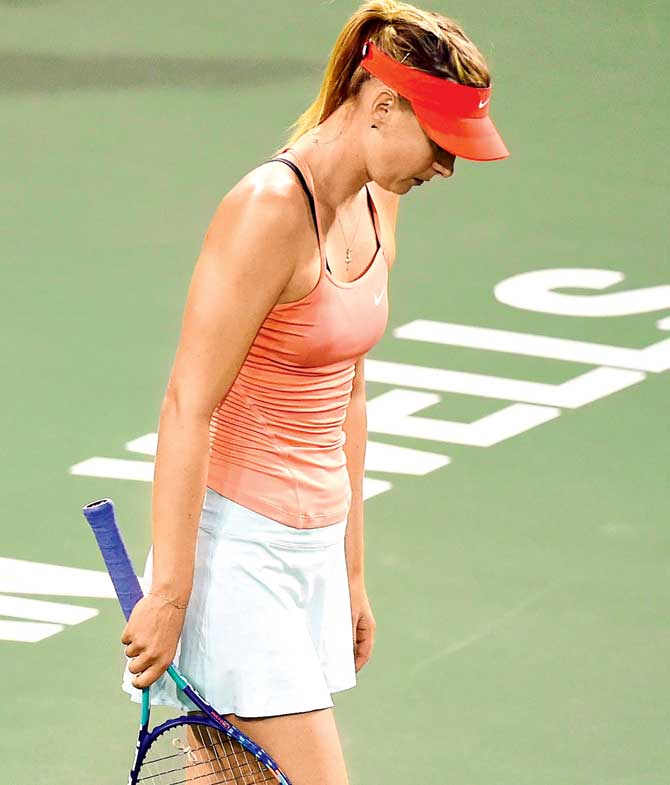 A dejected Maria Sharapova walks out of the court. Pic/AFP