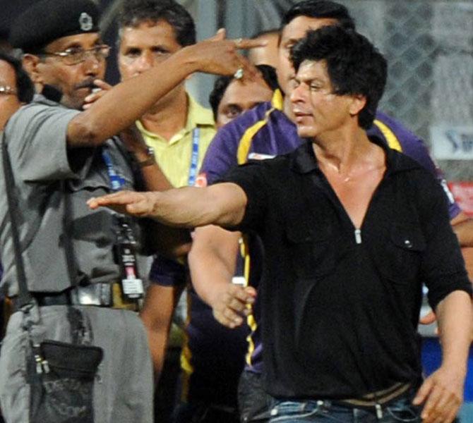 Bollywood actor and Indian Premier League franchise Kolkata Knight Riders co-owner Shah Rukh Khan (right in black shirt) walks away following an altercation with officials after the Mumbai Indians vs KKR match at the Wankhede Stadium on May 16, 2012. Pic/AFP 