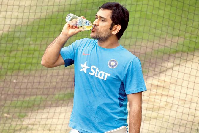 Mahendra Singh Dhoni sips a drink during a during a training session in Melbourne on Wednesday. PIC/AFP