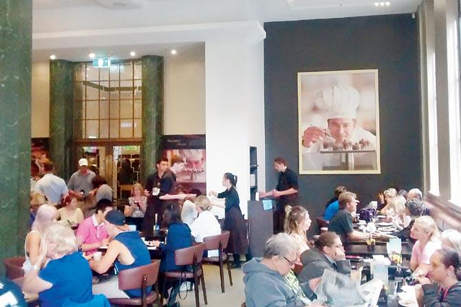 Patrons enjoy their coffee and snacks an the Lindt Chocolate Cafe in Sydney on Saturday