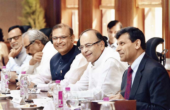 Finance Minister Arun Jaitley with MoS Finance, Jayant Sinha and RBI Governor Raghuram Rajan at the 550th Central Board Meeting of RBI. Pic/PTI