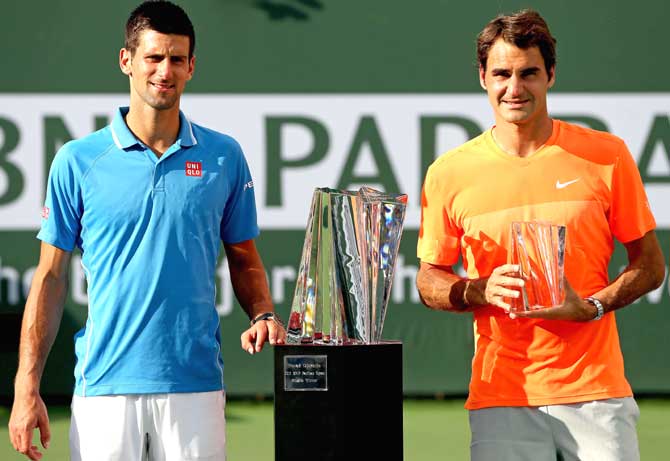 Novak Djokovic of Serbia and Roger Federer of Switzerland pose for photographers after the final on day fourteen of the BNP Paribas Open at the Indian Wells Tennis Garden. Pic/AFP