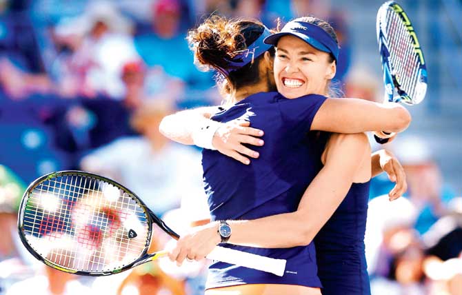 Sania Mirza and Martina Hingis (right) celebrate winning at Indian Wells yesterday. Pic/AFP