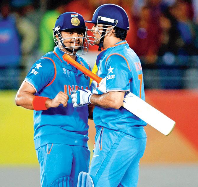 Suresh Raina and MS Dhoni celebrate India’s win over Zimbabwe in Auckland recently. Pic/Getty Images