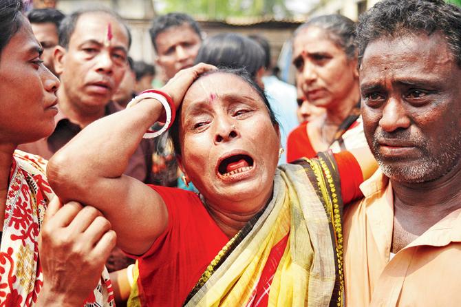 A women reacts after seeing the body of a relative in Narayanganj on Friday.